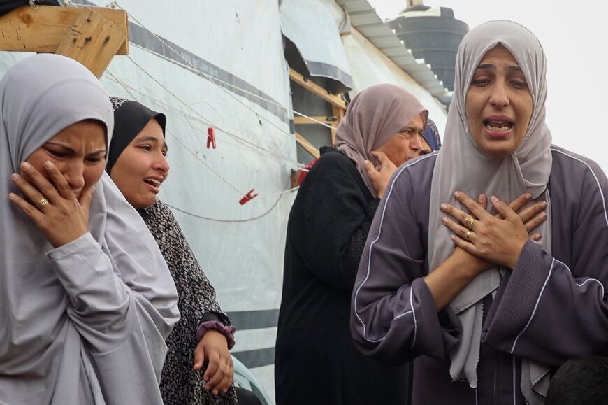 Palestinians at the site of the Israeli strike on the Rafah camp