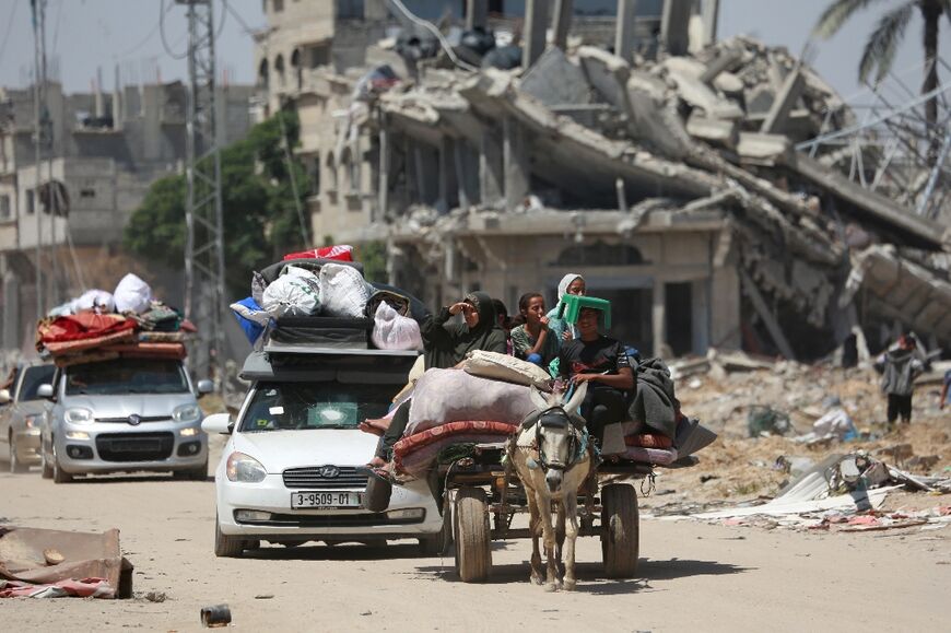 With possessions piled high atop junky cars or even donkey carts, Palestinians are on the move again, here returning to Khan Yunis city in southern Gaza