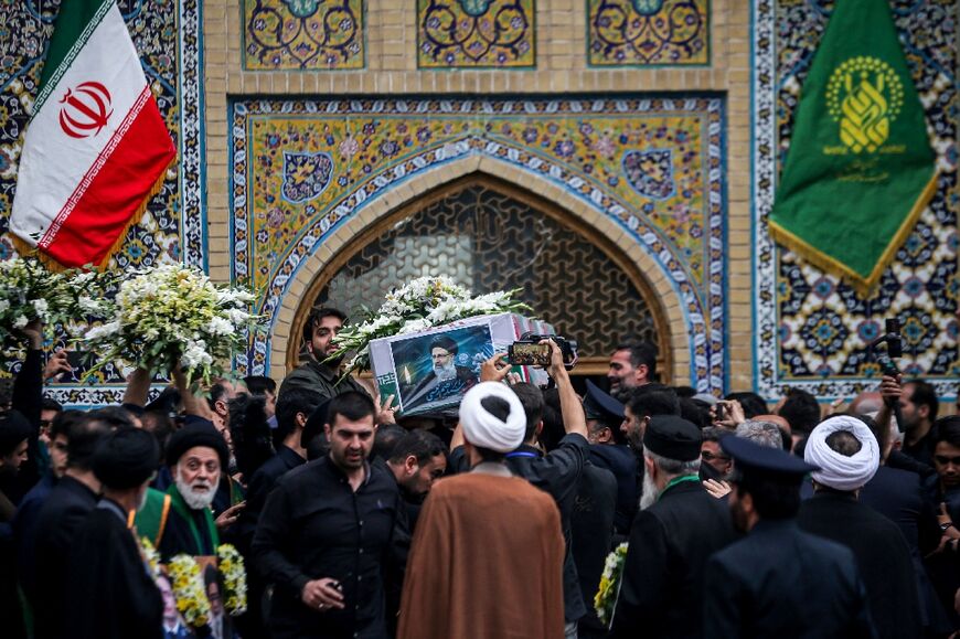 The coffin containing the remains of Iran's president Ebrahim Raisi is seen at the shrine of Masoomeh in Qom