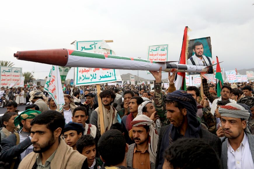 Demonstrators carry a mock missile during a pro-Palestinian and anti-Israel rally in Yemen's Huthi-held capital Sanaa on April 26