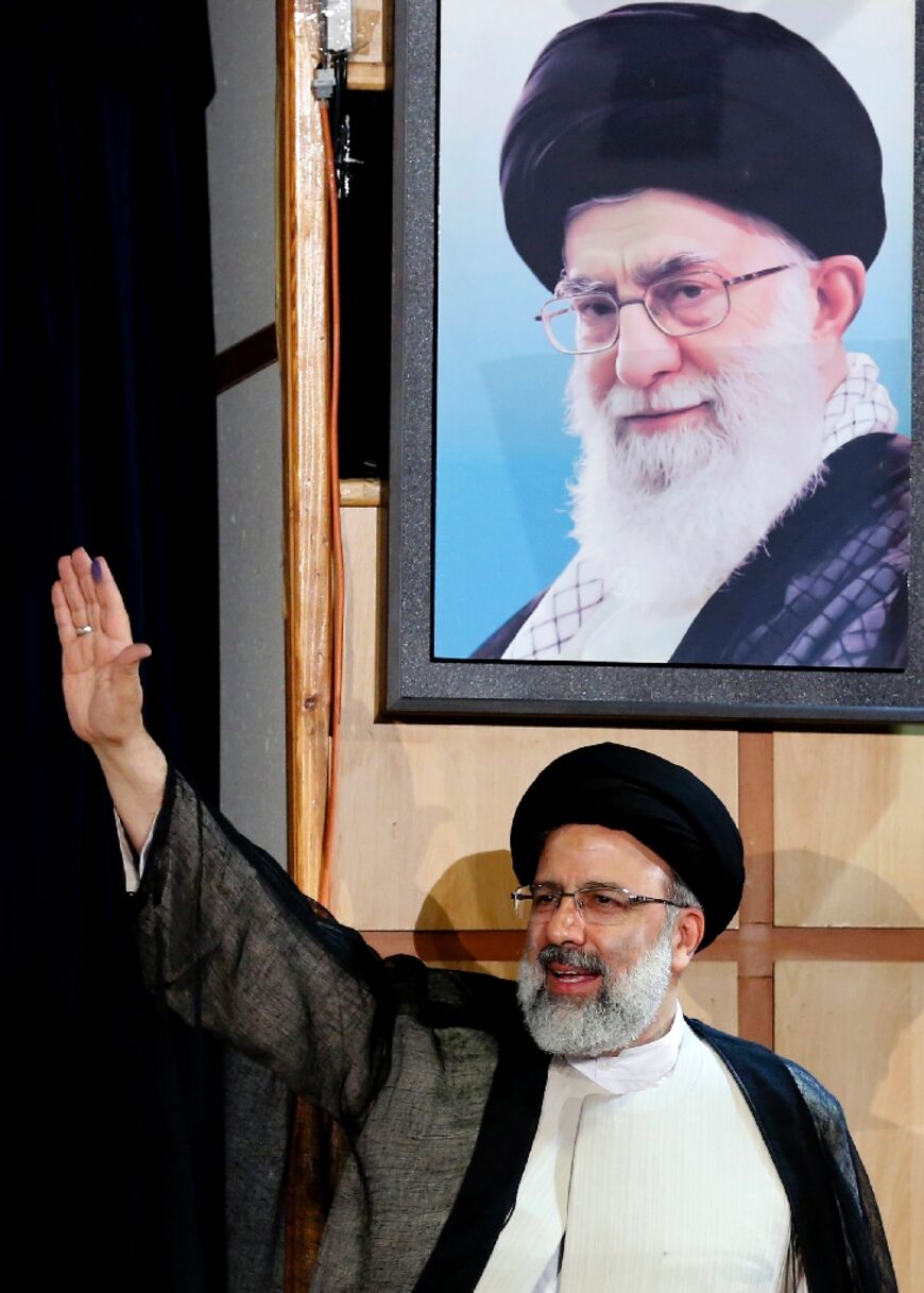 The late president under a portrait of supreme leader Ayatollah Ali Khamenei, the man he had been expected to succeed
