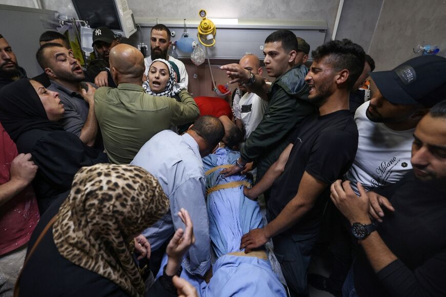 Mourners surround the body of Palestinian Muhammad Safi, before his funeral in Ramallah in the occupied West Bank on May 15, 2024, after he was killed by an Israeli army bullet, according to Palestinian authorities