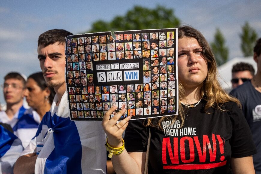 A participant with a placard showing pictures of hostages held by Hamas in Gaza