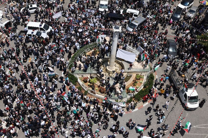 Palestinian protesters gather in the main square of the West Bank city of Ramallah on May 15, 2024 