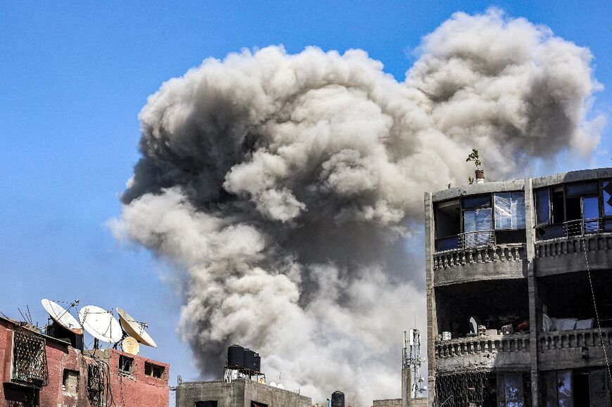 A smoke plume rises during Israeli bombardment in Jabalia in the northern Gaza Strip on May 14, 2024 
