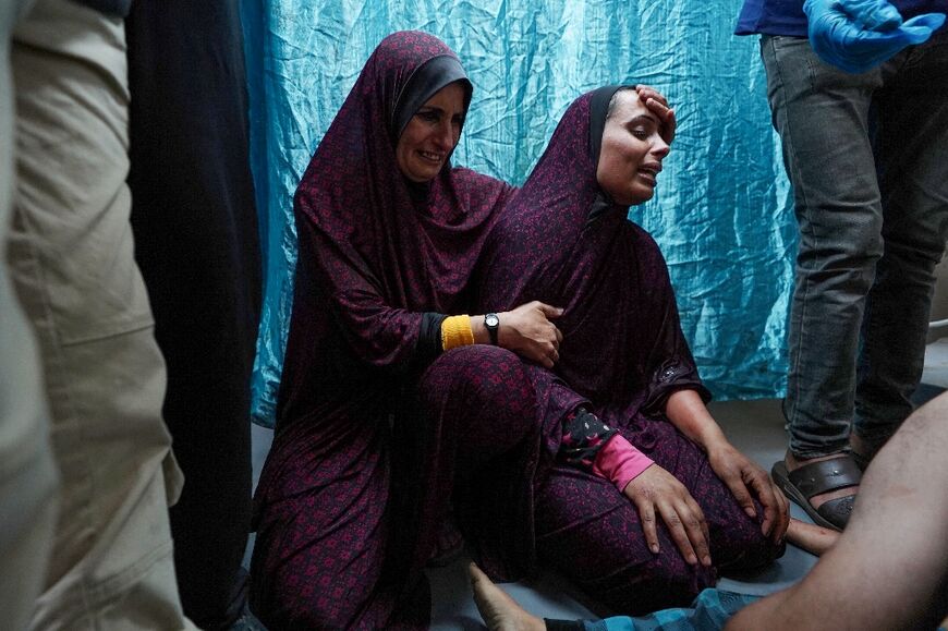 A Palestinian women reacts after her son was rushed to hospital following an Israeli strike on central Gaza's Nuseirat