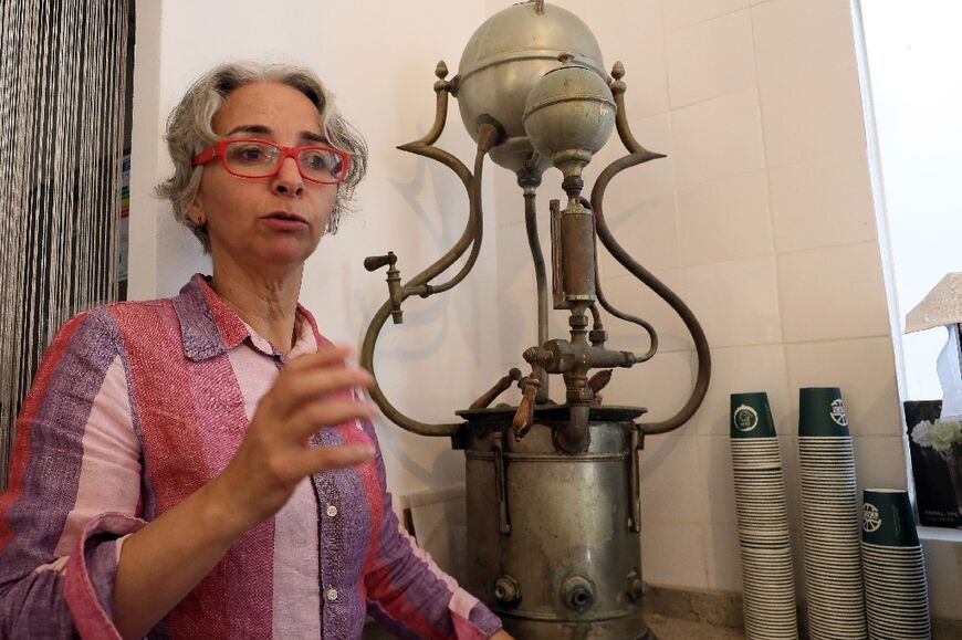 The artist's daughter Hadia talks about the museum's aims in front of an old coffee making machine that is among the exhibits