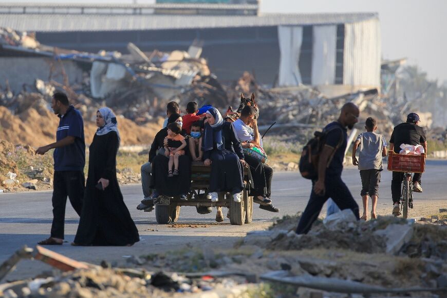 Displaced Palestinians flee heavy fighting in central Gaza's Al-Maghazi refugee camp