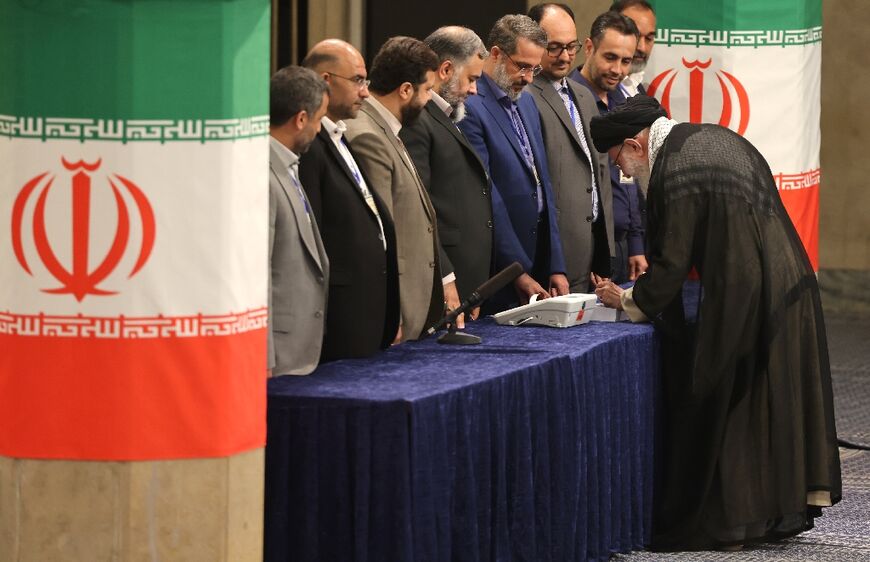 Iran's supreme leader Ayatollah Ali Khamenei, who holds ultimate political power, casts his ballot during the presidential election