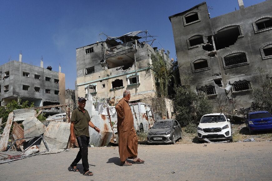 Palestinians inspect damage to buildings following the hostage rescue raid in the Nuseirat camp in the central Gaza Strip on June 8, 2024