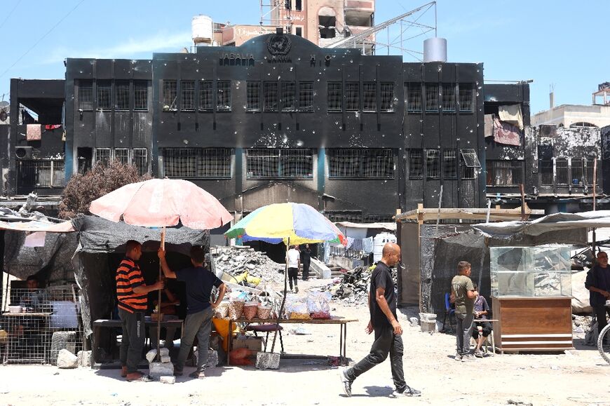 Stalls set up by vendors outside a charred UN building in north Gaza's Jabalia refugee camp