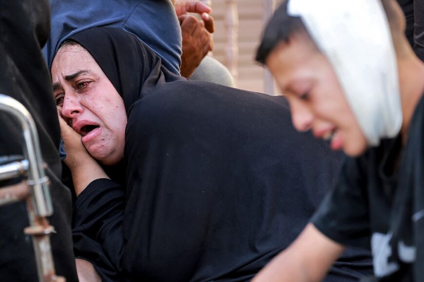 A mother mourns her son who was killed in overnight Israeli bombardment in al-Maghazi in the central Gaza Strip, outside the morgue of the Aqsa Martyrs hospital in Deir el-Balah on June 25, 2024 