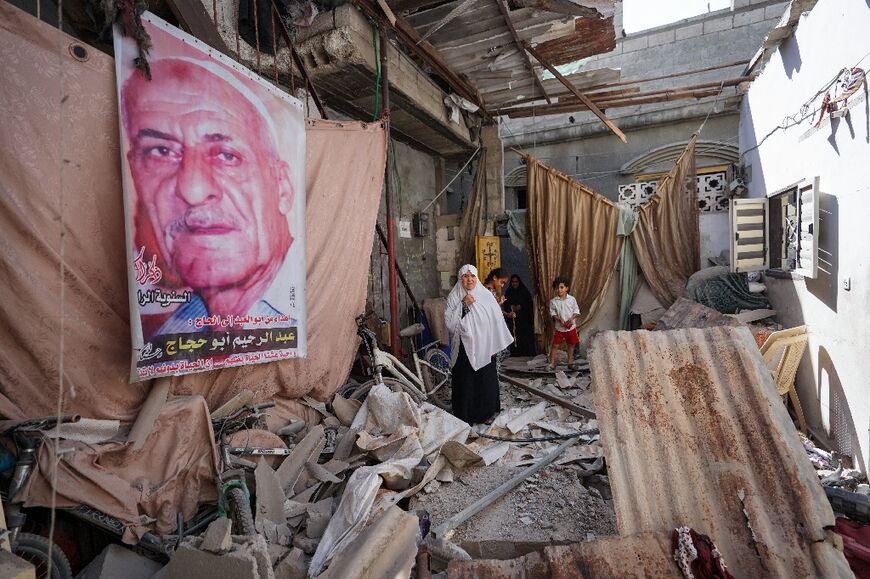 Palestinians search the rubble of the Al-Rai family home which was hit at dawn in Israeli bombardment of Nuseirat city in the central Gaza Strip