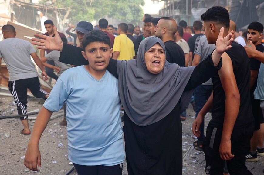 A woman reacts as people search for survivors after Israeli bombardment at Bureij refugee camp, central Gaza
