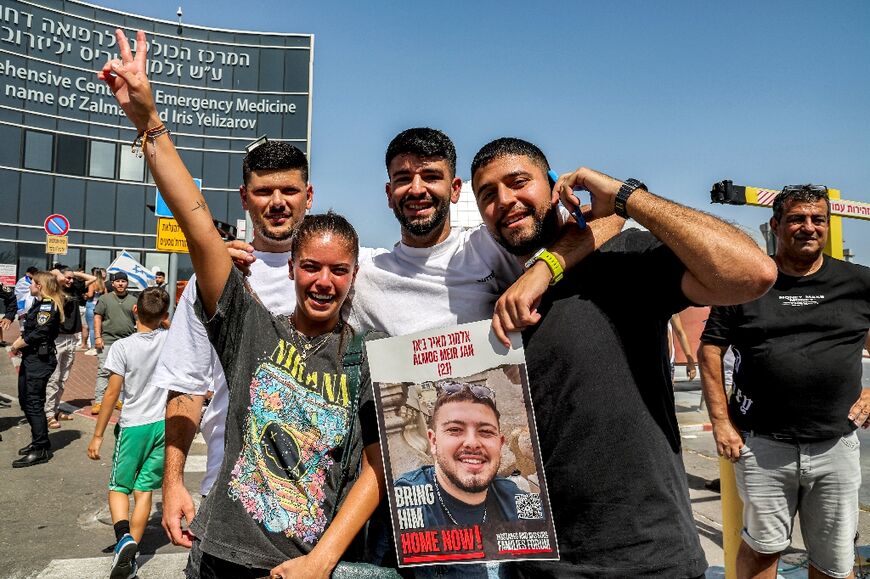 Friends of Almog Meir Jan, one of the four hostages rescued from Gaza, outside the hospital where he is treated