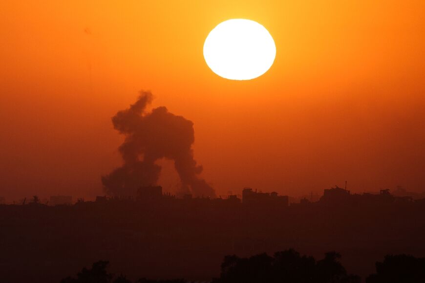 Smoke billowing in Gaza at sunset following Israeli bombardment, as the war nears its ninth month