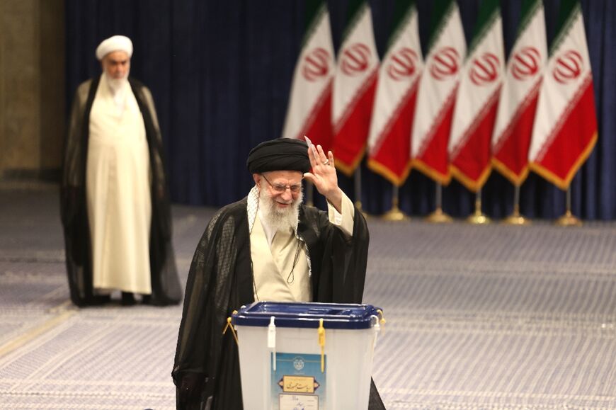 Iran's supreme leader Ayatollah Ali Khamenei waves as he casts his ballot