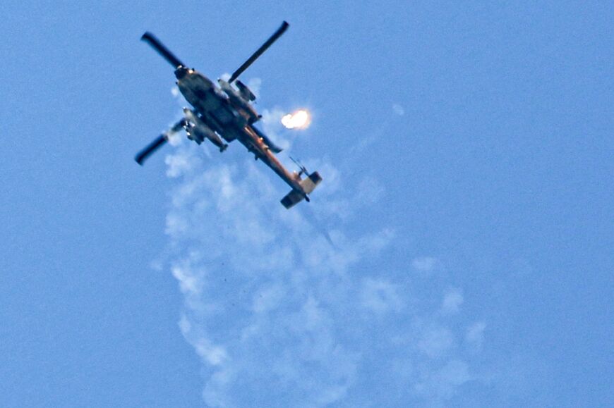 An Israeli air force attack helicopter releases flares while flying near Rafah, the southern Gaza Strip