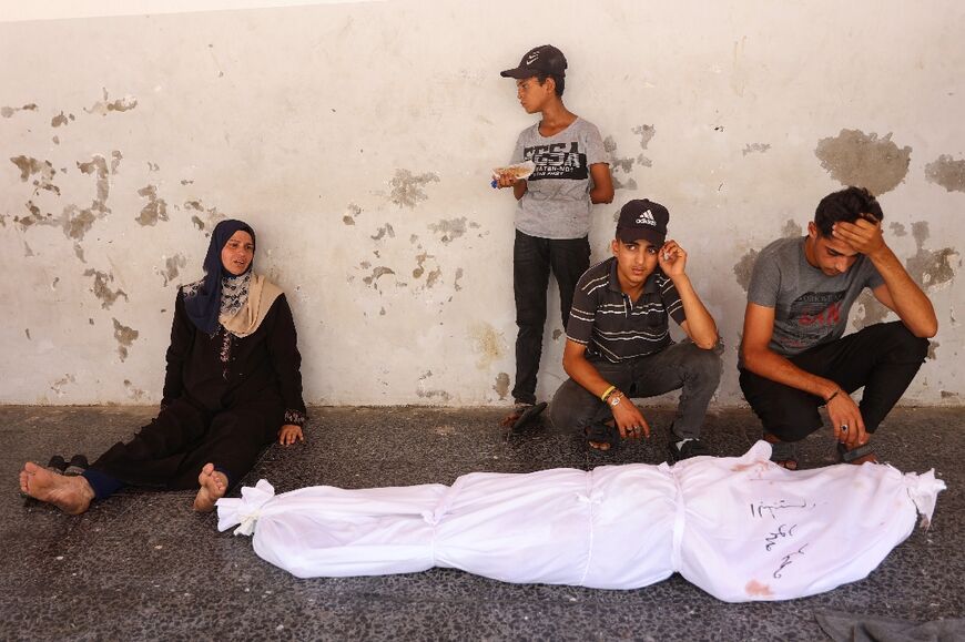 People mourn over the body of a Palestinian killed during Israeli bombardment in Gaza City