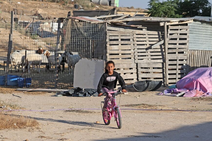 A girl cycles through Ras Jrabah east of the city of Dimona in southern Israel 