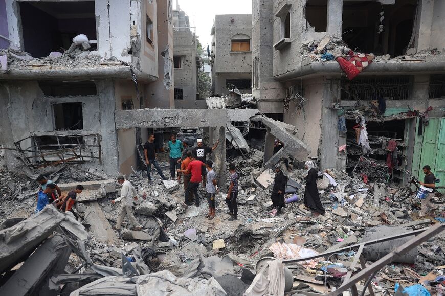Palestinians inspect the damage and debris after an operation by the Israeli forces in the Nuseirat camp in central Gaza