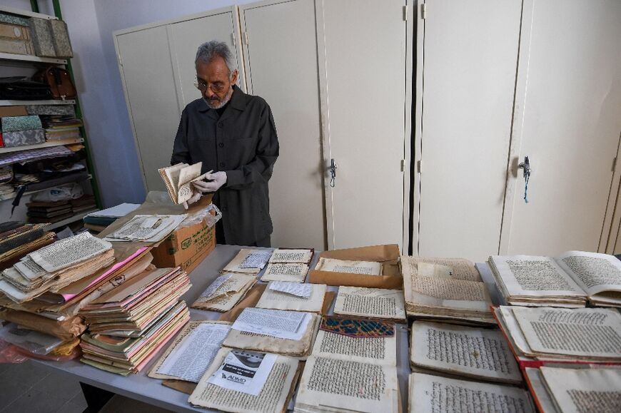 The manuscripts are dusted and scanned for digital copies, which Barouni believes is "today's only solution" to preserve the old texts