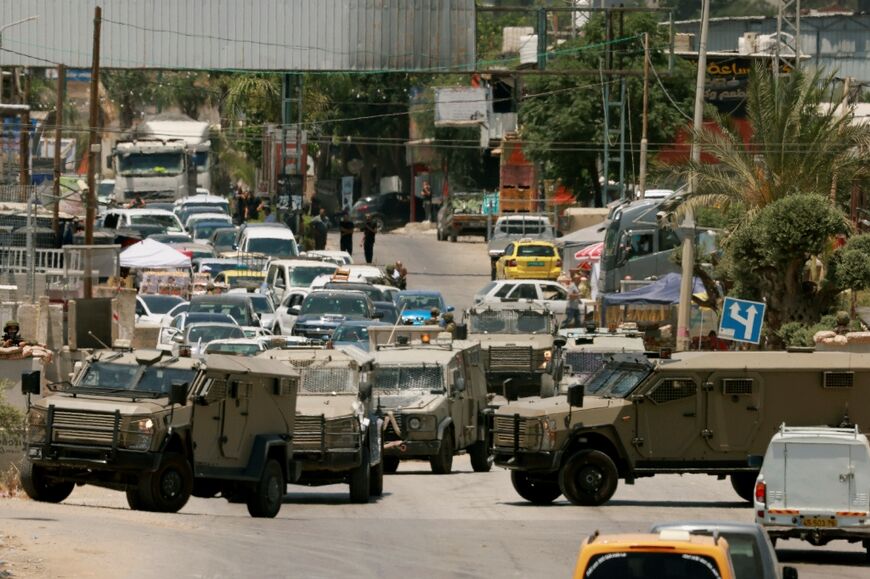 Israeli army vehicles close off the entrance to Qalqilya in the occupied West Bank after an Israeli civilian was shot and killed 