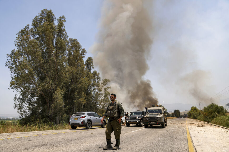 Israeli army soldiers deploy along a road near the site where rockets fired from south Lebanon landed near Kfar Szold in the Upper Galilee in northern Israel on June 14, 2024. Fallout from the Gaza war is regularly felt on the Israeli-Lebanon frontier, where deadly cross-border exchanges have escalated. (Photo by Jalaa MAREY / AFP) (Photo by JALAA MAREY/AFP via Getty Images)
