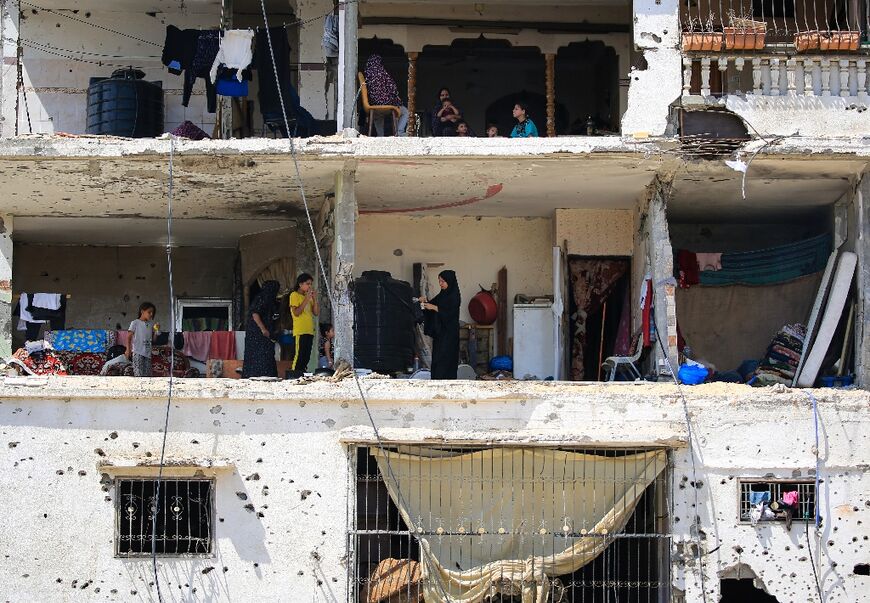 Palestinians families return to badly damaged homes in Khan Yunis, in the southern Gaza Strip
