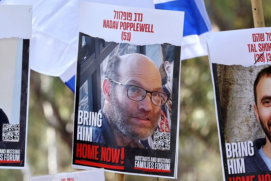 A poster with the portrait of Nadav Popplewell at an Israeli rally calling for hostage release, in February
