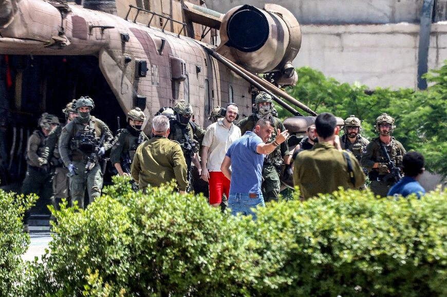 Israeli hostage Andrey Kozlov, 27, disembarks with soldiers from an air force CH-53 Sea Stallion helicopter after his rescue from captivity in the Gaza Strip, near Tel Aviv on June 8, 2024