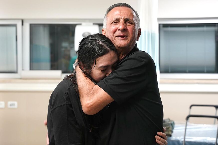 Freed Israeli hostage Noa Argamani, 26, is embraced by her father at a hospital on June 8, 2024