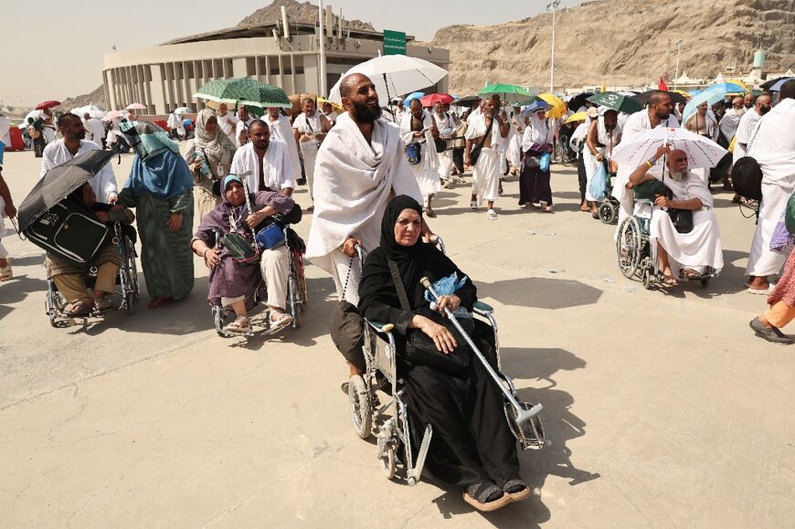 Muslim pilgrims arrive to perform the symbolic 'stoning of the devil' ritual as part of the hajj in Mina, near Saudi Arabia's holy city of Mecca, during oven-like heat conditions