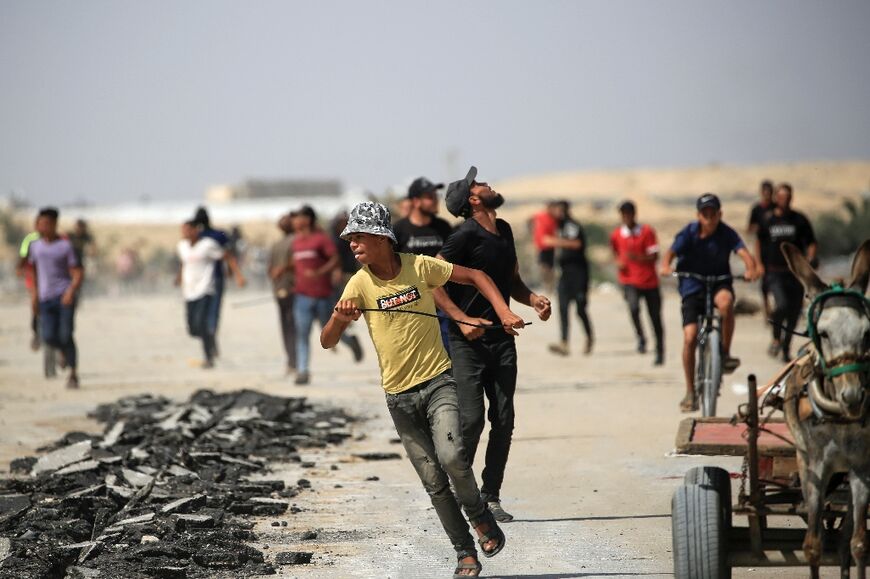 People run for cover during an Israeli drone strike in the Rafah area, southern Gaza