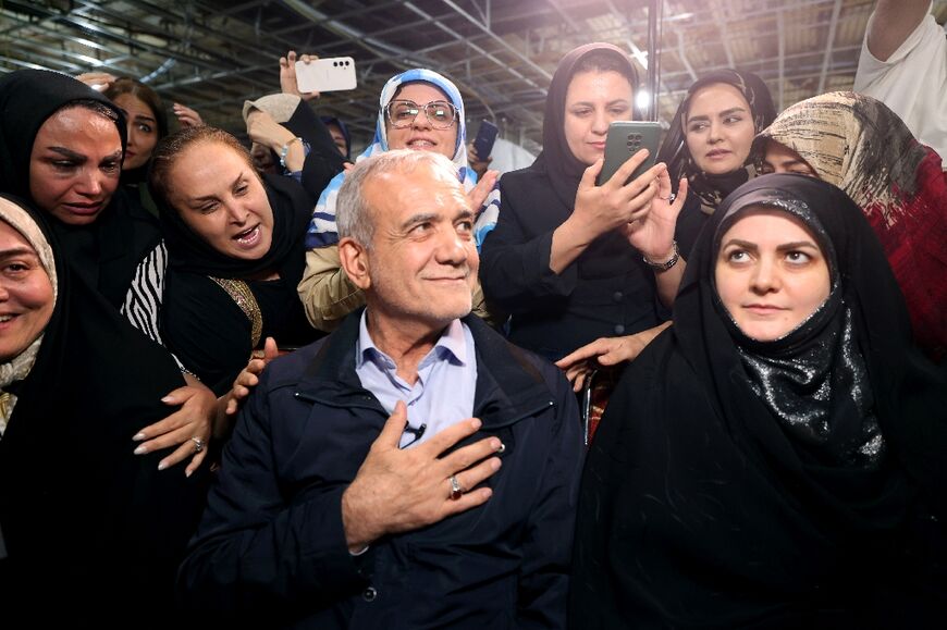The sole reformist candidate, Masoud Pezeshkian, meets women during campaigning in Tehran
