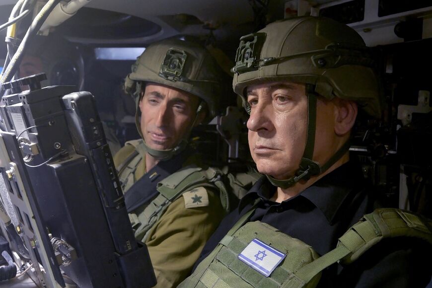 Israeli Prime Minister Benjamin Netanyahu (R) is seen visiting troops in Gaza's southernmost city of Rafah Thursday in this picture released by his office