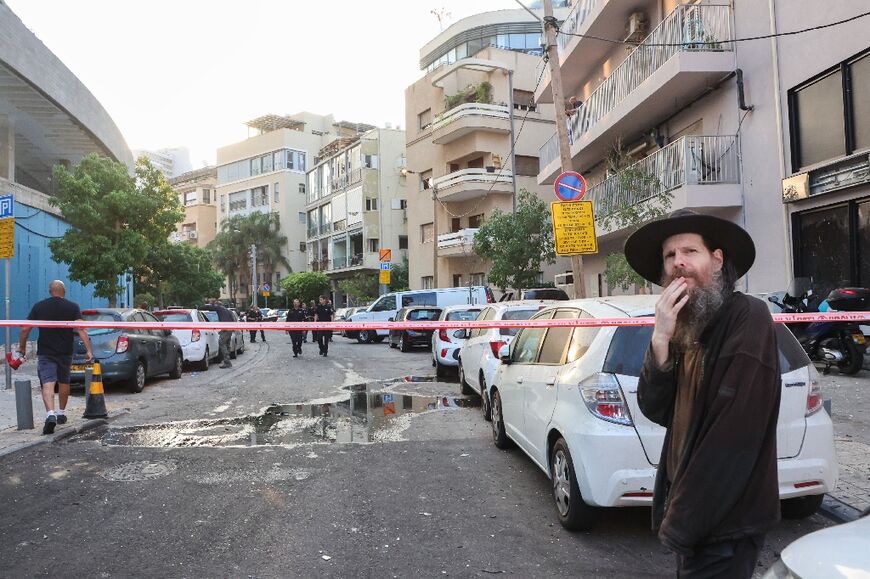 Cars and windows were battered all along the Tel Aviv street where a drone hit killing one man and injuring a number of others