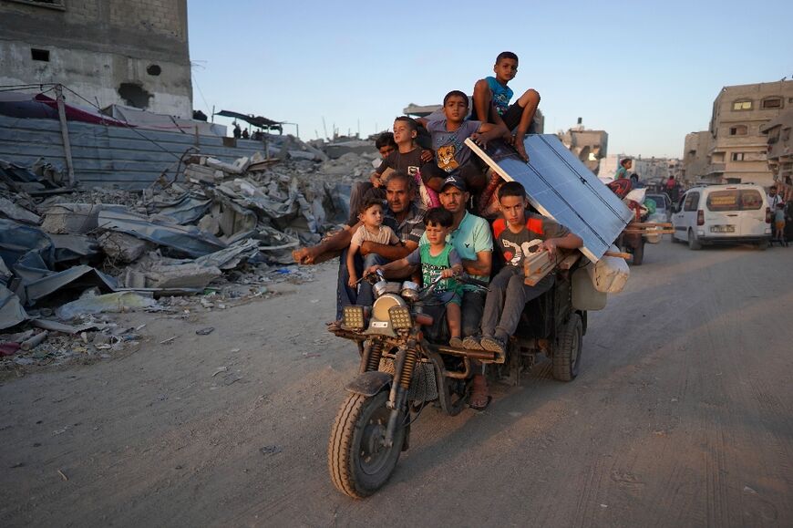 Displaced Palestinians leave east Khan Yunis after the Israeli army issued a new evacuation order in Gaza