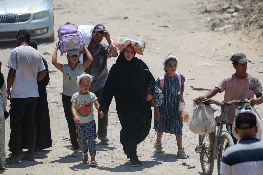 Palestinian civilians leave an area of Khan Yunis that Israel had designated a humanitarian zone