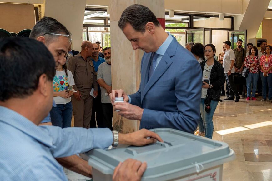 The Syrian presidency published images of Bashar al-Assad voting at a polling booth in Damascus
