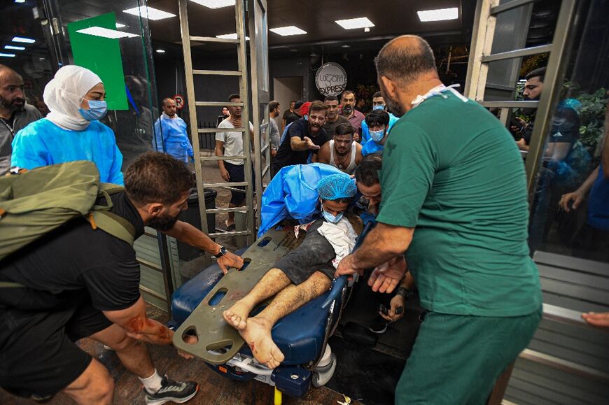 A wounded Lebanese being taken to the Bahman hospital in Beirut after the Israeli strike