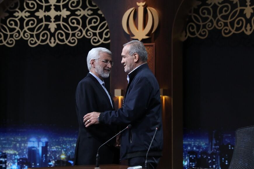 The ultraconservative Saeed Jalili (L) and reformist Masoud Pezeshkian (R) greet each other after taking part in a televised debate