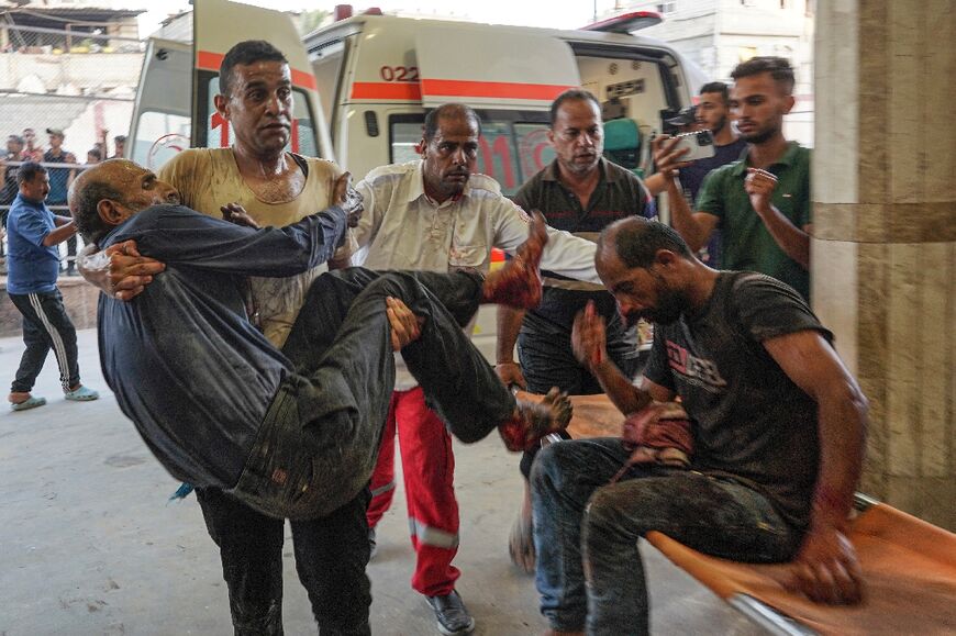 Palestinians wounded in a strike on a school turned shelther in southern Gaza are brought to Nasser hospital in Khan Yunis