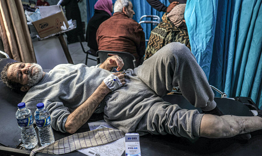 A man, who was detained with other Palestinians by the Israeli military during their operation in the northern Gaza Strip and recently released through the Kerem Shalom crossing, awaits treatment for his injuries at al-Najjar hospital in Rafah in the southern Gaza Strip on December 24, 2023, amid the ongoing conflict between Israel and the Palestinian militant group Hamas. (Photo by SAID KHATIB / AFP) (Photo by SAID KHATIB/AFP via Getty Images)