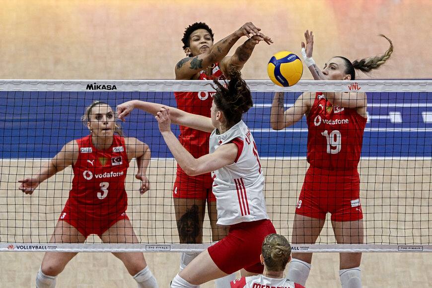 Turkey's (top, L-R) Cansu Özbay, Melissa Teresa Vargas and Asli Kalac blocks Poland's Martyna Lukasik's (C) attempt to spike the ball during the FIVB Women's Volleyball Nations League match between Poland and Turkey in Bangkok on June 21, 2024. (Photo by Lillian SUWANRUMPHA / AFP) (Photo by LILLIAN SUWANRUMPHA/AFP via Getty Images)
