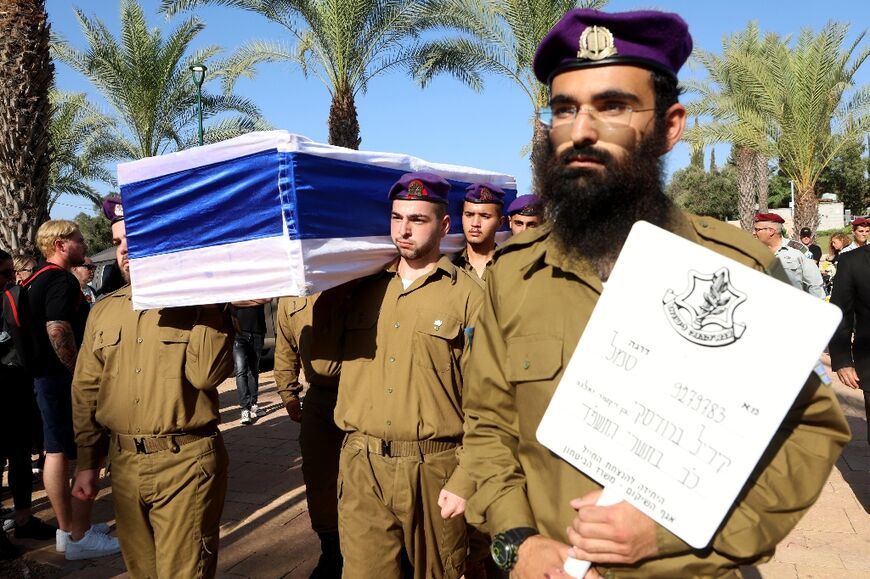 Israeli soldiers carry the coffin of Sgt. Kiril Brodski, 19, who was killed during the Hamas attack on southern Israel on October 7 and whose body was then taken to the Gaza Strip