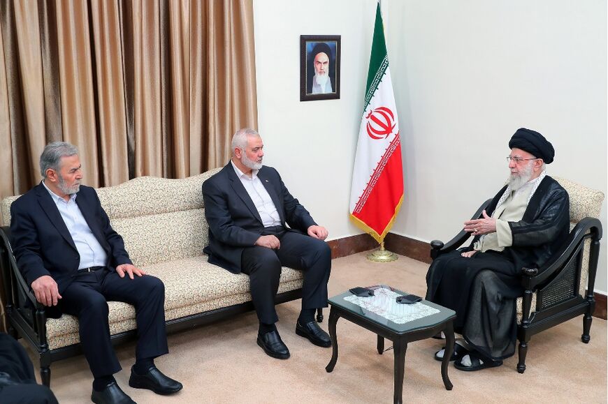 A handout picture provided by the office of Iran's Supreme Leader Ayatollah Ali Khamenei shows him (R) meeting with leaders of the Palestinian Hamas movement Ismail Haniyeh (C) and the Islamic Jihad group Ziad al-Nakhaleh in Tehran on July 30, 2024