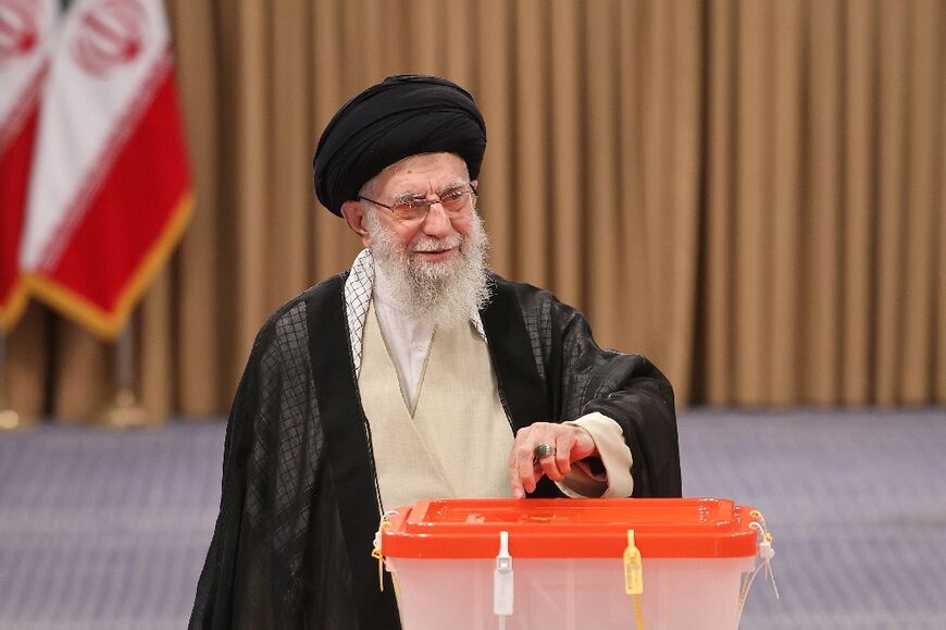 Iran's supreme leader Ayatollah Ali Khamenei casts his ballot during the runoff