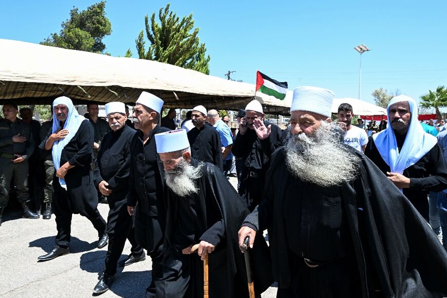 Elderly members of the Druze community gather in solidarity with the victims of the attack in Majdal Shams, in the Syrian town of Quneitra, close to the Israeli-annexed Golan Heights