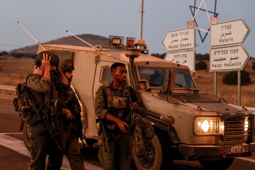 Israeli soldiers secure a road in the annexed Golan Heights amid rocket fire from Lebanon